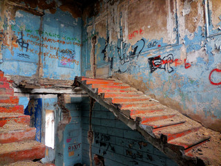 graffiti on the wall and an old staircase