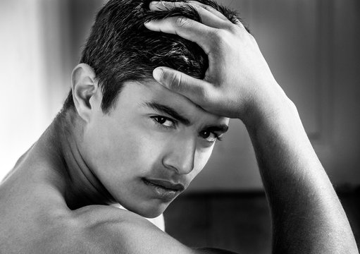 Portrait of muscular hispanic man looking at camera