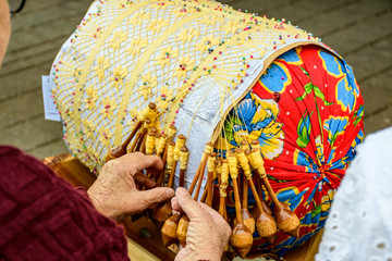 craftswoman making traditional bobbin lace handicrafts - 280023080