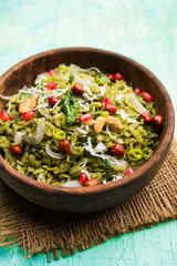 Hariyali Poha / Green Masala Pohe or flattened rice served in a bowl, selective focus
