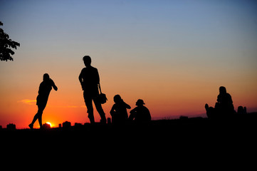 Fototapeta na wymiar BELGRADE, SERBIA - AUGUST 18, 2015: Silhouettes of young people during sunset in Kalemedan park at fortress in Belgrade, Serbia