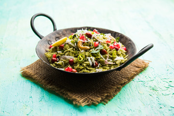 Hariyali Poha / Green Masala Pohe or flattened rice served in a bowl, selective focus