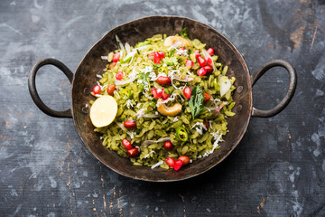 Hariyali Poha / Green Masala Pohe or flattened rice served in a bowl, selective focus