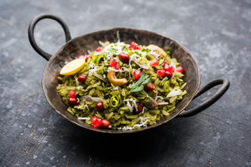 Hariyali Poha / Green Masala Pohe or flattened rice served in a bowl, selective focus