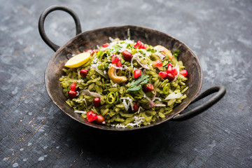 Hariyali Poha / Green Masala Pohe or flattened rice served in a bowl, selective focus