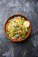 Hariyali Poha / Green Masala Pohe or flattened rice served in a bowl, selective focus