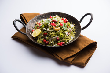 Hariyali Poha / Green Masala Pohe or flattened rice served in a bowl, selective focus