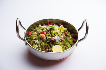 Hariyali Poha / Green Masala Pohe or flattened rice served in a bowl, selective focus
