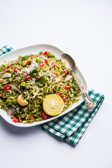 Hariyali Poha / Green Masala Pohe or flattened rice served in a bowl, selective focus