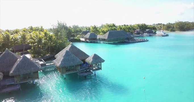 Beach travel vacation Tahiti hotel overwater bungalows luxury resort in coral reef lagoon ocean. Moorea, French Polynesia, Tahiti, South Pacific Ocean. Bora Bora
