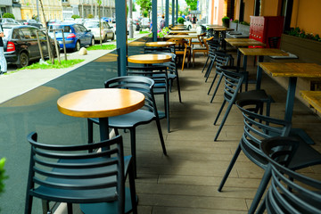 modern plastic black chairs and tables in the cafe, outdoor terrace