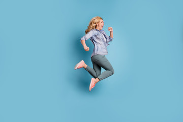 Fototapeta na wymiar Profile side full length photo of delighted person shouting wearing pants trousers isolated over blue background