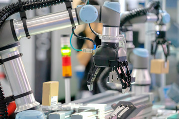 Factory 4.0 concept :View of Gripper on universal robot is sorting goods and cowork with other...