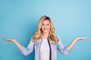 Portrait of charming lady holding hands smiling isolated over blue background