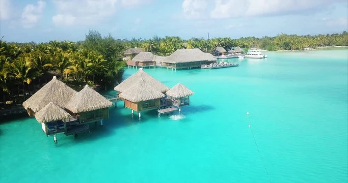 Beach travel vacation Tahiti hotel overwater bungalows luxury resort in coral reef lagoon ocean. Moorea, French Polynesia, Tahiti, South Pacific Ocean. Bora Bora