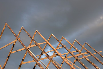 Rafters from logs of the correct geometrical form of a triangle. Saturated blue sky before a...