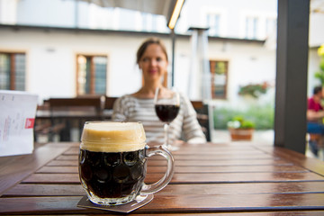 Young beautiful girl on the background of a glass of beer.