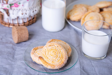 Cottage cheese homemade cookie in sugar topping with milk. Selective focus, close-up.