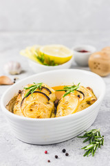 Lemon rosemary chicken breasts in a baking dish. Selective focus, space for text.