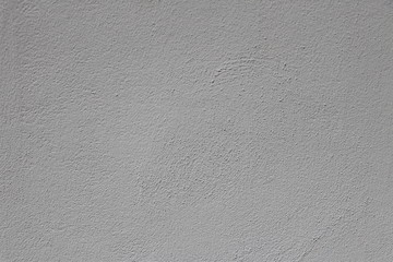 Texture of a smoothly plastered grey stonewall, background with copy space