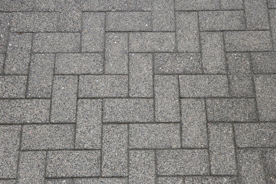 Herringbone pattern, abstract background with pavers on an urban walkway