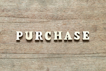Letter block in word purchase on wood background