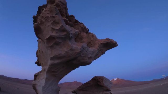 Isolated rock formation named Arbol de Piedra (Rock Tree) located in the Andean desert. Panorama up and down shot at sunrise. Bolivia, Altiplano