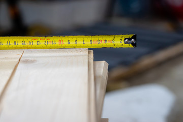 measuring wood to be cut with a measure