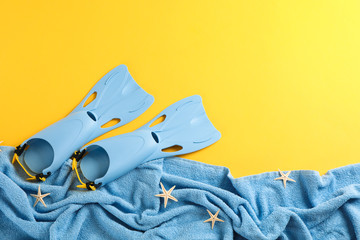 Sea vacation accessories on yellow background, top view