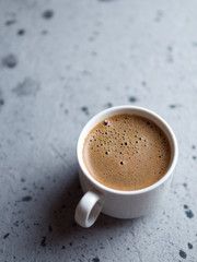 White espresso coffee Cup on grey stone table with copyspace