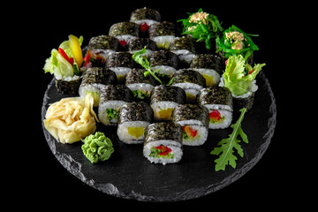 Sushi set with fresh ingredients on black background. Sushi menu. Japanese food. 