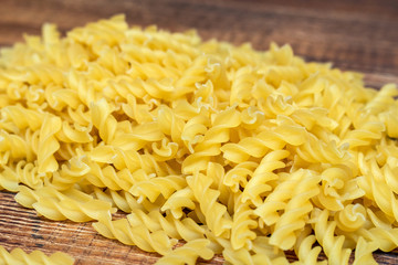 spaghetti, fusilli, macaroni, pasta traditional Italian on wooden background close up selective focus