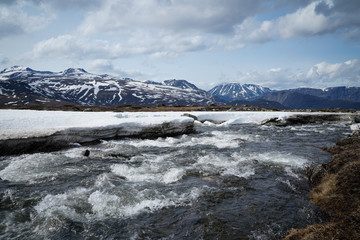 Wild lowing water in the icy mountains of Norway's Jotenheimer. 