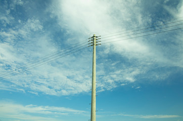 Obraz premium utility pole on blue cloudy sky