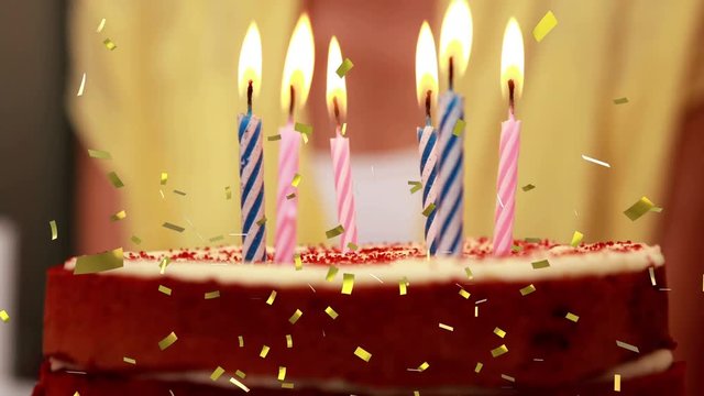 Candles on a birthday cake and confetti