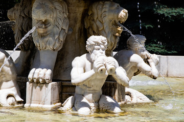 Fototapeta na wymiar Marble sculpture. Fountain in the city park
