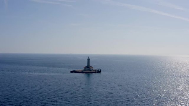 DRONE SHOT flying towards a lighthouse on a small island off the coast, Croatia