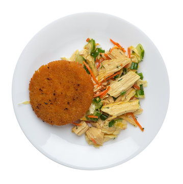 fishcake with soy asparagus and carrots, cucumbers and dilll.  fish cutlet on a plate isolated. cutlet with vegetables top view