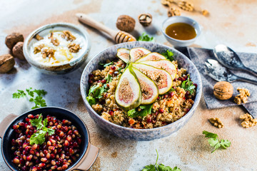 close-up view of tasty healthy couscous salat with figs fruits, nuts and pomegranate seeds 