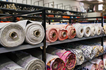 Fabric warehouse with many multicolored textile rolls