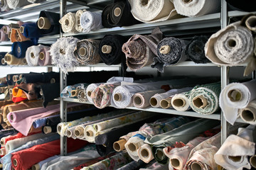 Fabric warehouse with many multicolored textile rolls