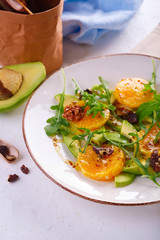 fresh avocado and orange salad on a beige plate