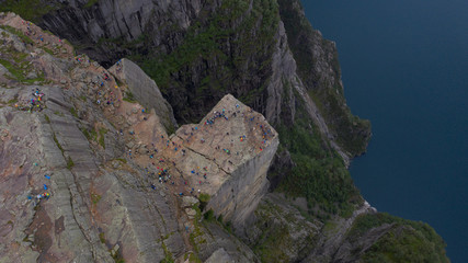 Preikestulen Norway. People enjoy the view from the mountain. July 2019.