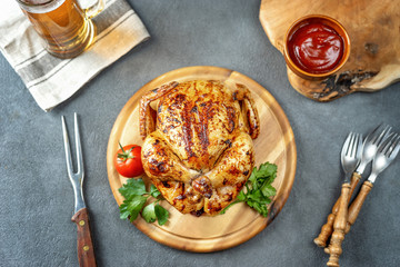 Top view of roasted chicken on rustic background