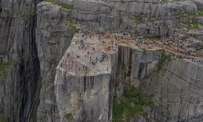 Preikestulen Norway. People enjoy the view from the mountain. July 2019.