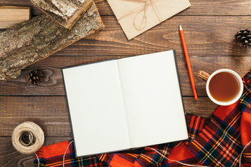 Hygge style autumn flatlay composition. Book with empty pages, fashion feminine red scarf, rope,...