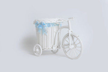 Fototapeta na wymiar Toy bike with basket on white background. The concept of props.