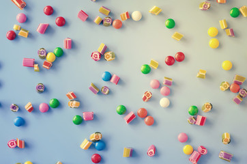 Background with scattered multicolored chocolate candy and sugar candy.