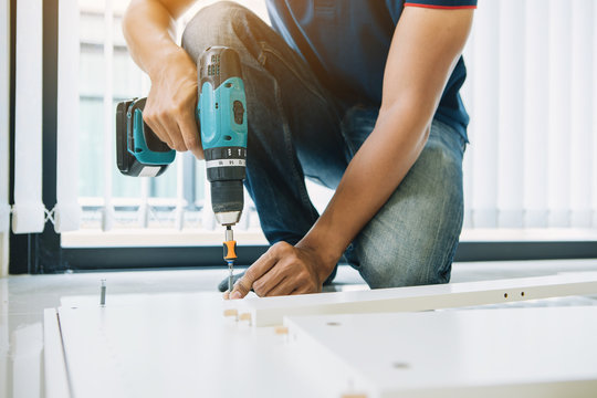 Service man assembling furniture for customer, Delivery service furniture store and assembling for buyer.