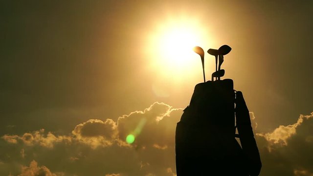 Silhouette Golf clubs is in the bag with the rain and the cold light of sunset footage timelapse